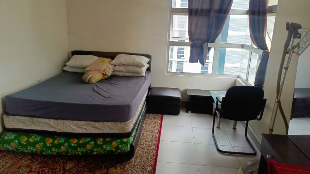 Small bedroom with a bed, desk, and chair near a window.