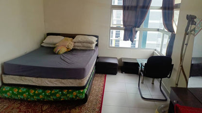 Small bedroom with a bed, desk, and chair near a window.